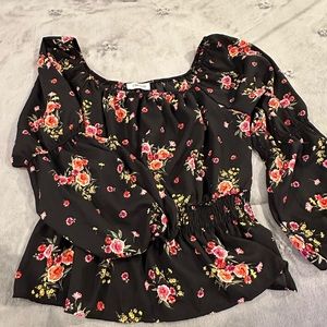 Floral top, elastic waste, flared at bottom, puffy sleeves and wide neck